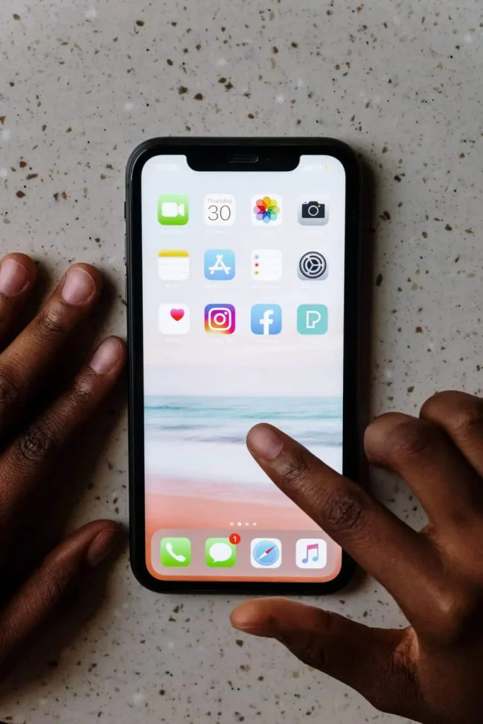 A picture showing the Display of iPhone XR and a hand using it.